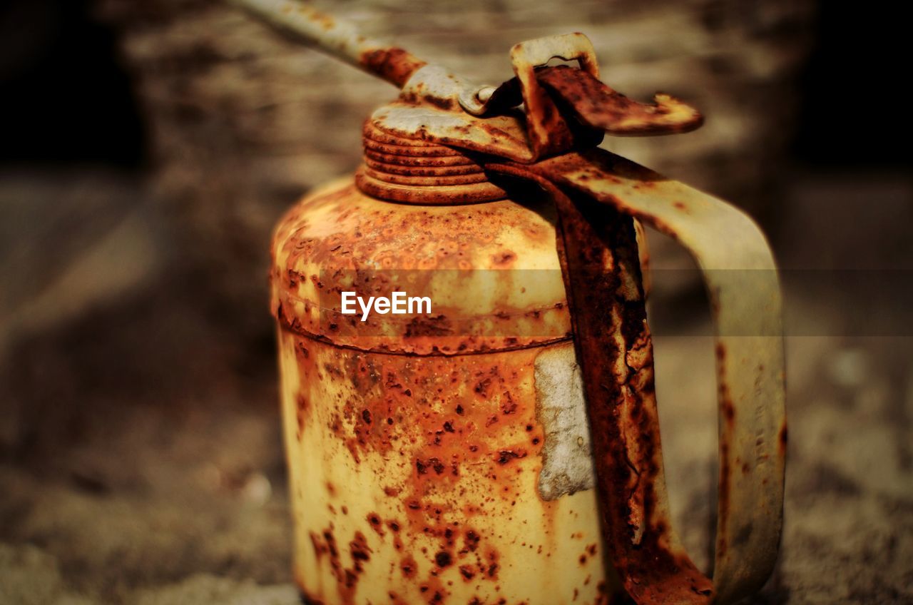 CLOSE-UP OF RUSTY METAL ON WOOD