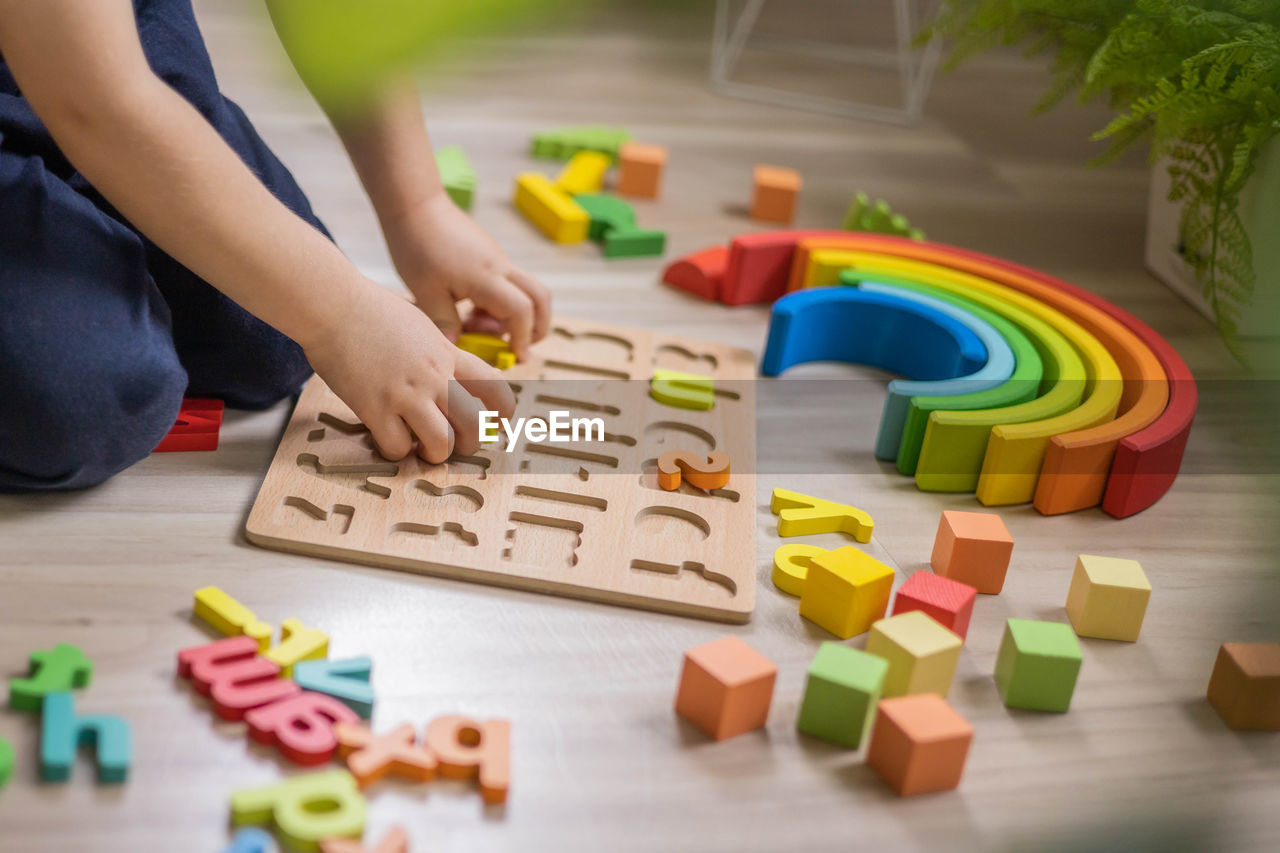 high angle view of person with toy blocks on table