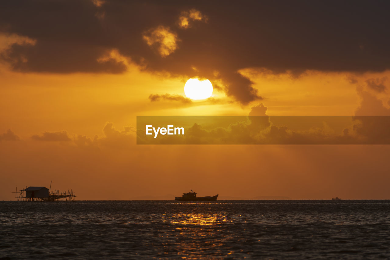 SCENIC VIEW OF SEA AGAINST ORANGE SKY DURING SUNSET