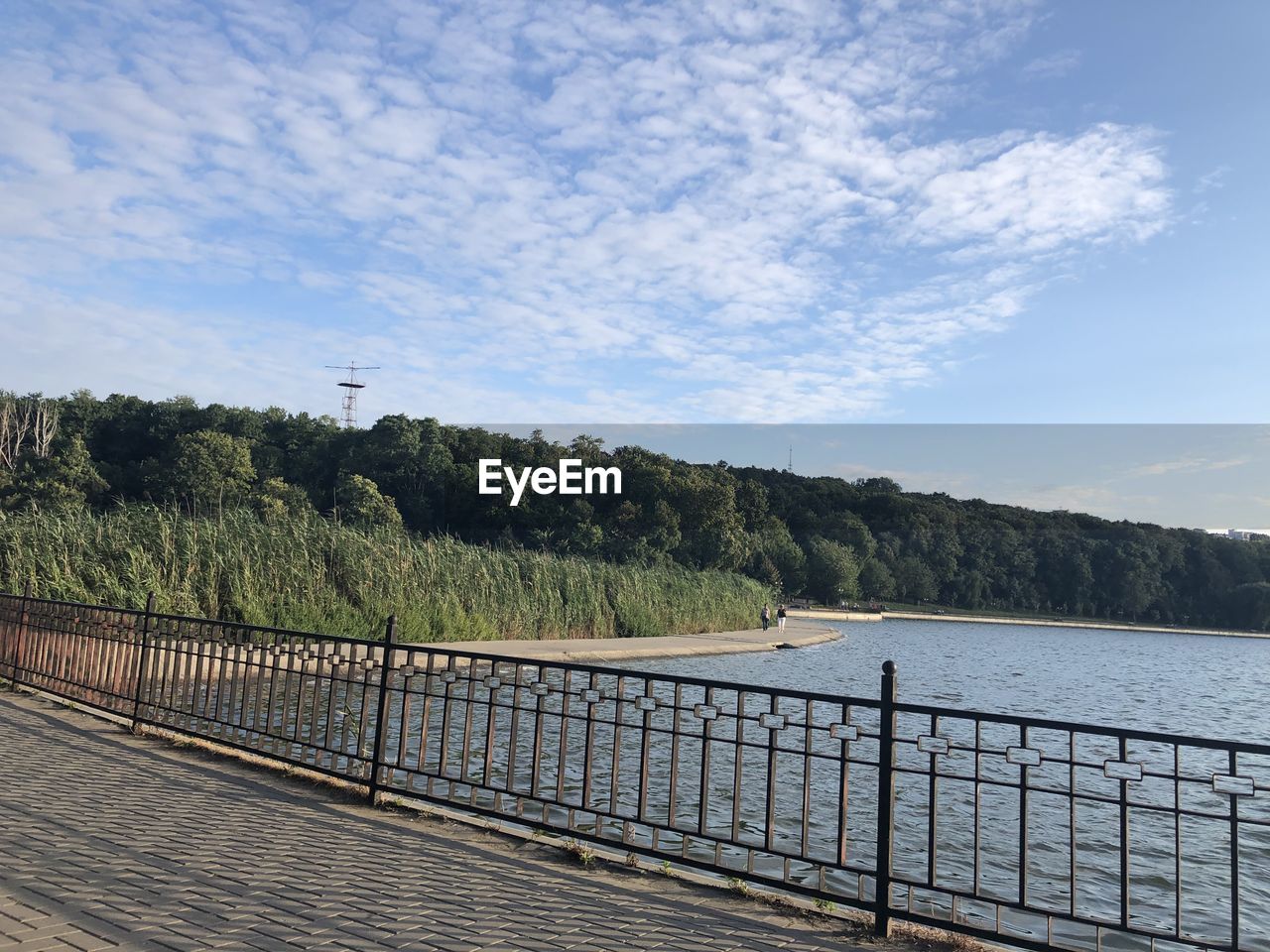 Scenic view of lake by mountains against sky