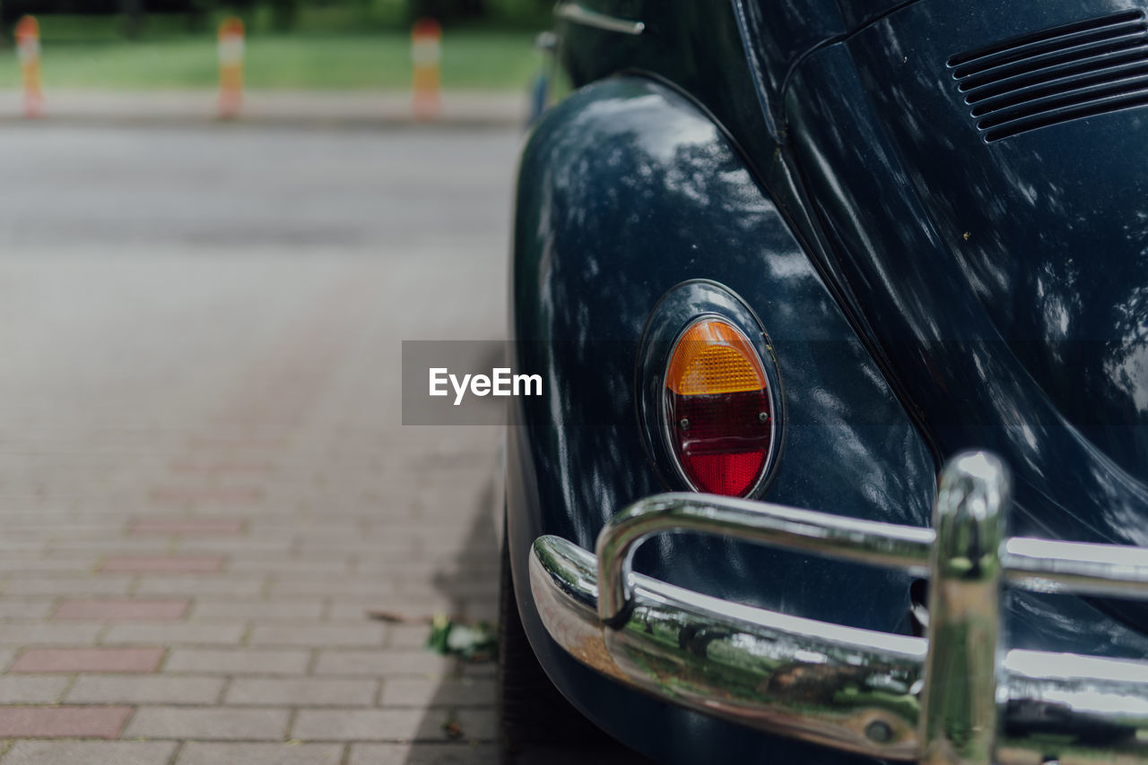 car, mode of transportation, transportation, vehicle, motor vehicle, land vehicle, automotive exterior, wheel, street, focus on foreground, automobile, day, luxury vehicle, city, no people, outdoors, close-up, headlight, retro styled, sports car