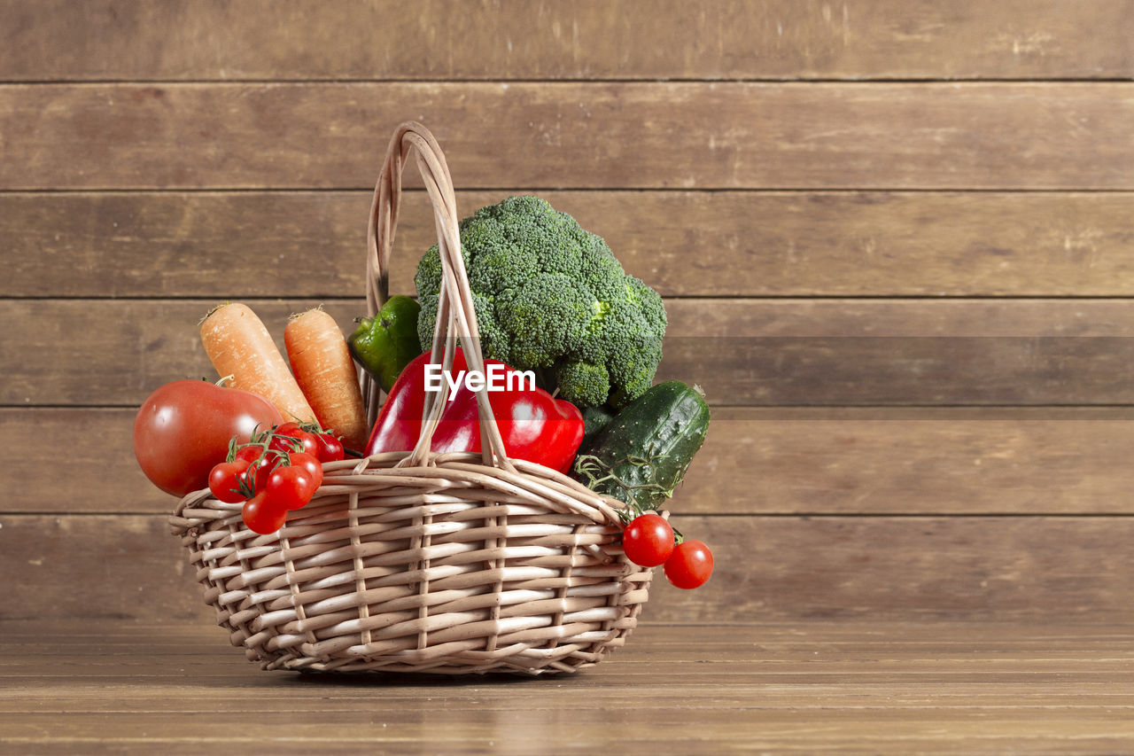 food and drink, food, basket, vegetable, healthy eating, freshness, wood, container, wellbeing, fruit, produce, wicker, tomato, no people, red, picnic basket, organic, rustic, indoors, still life, table, root vegetable, pepper, studio shot, carrot, nature, green