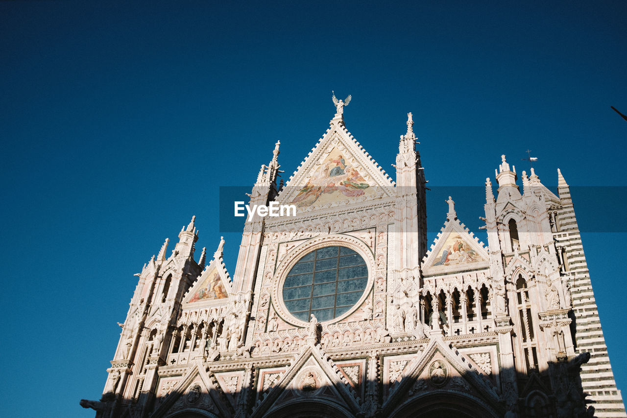 Low angle view of cathedral against clear blue sky