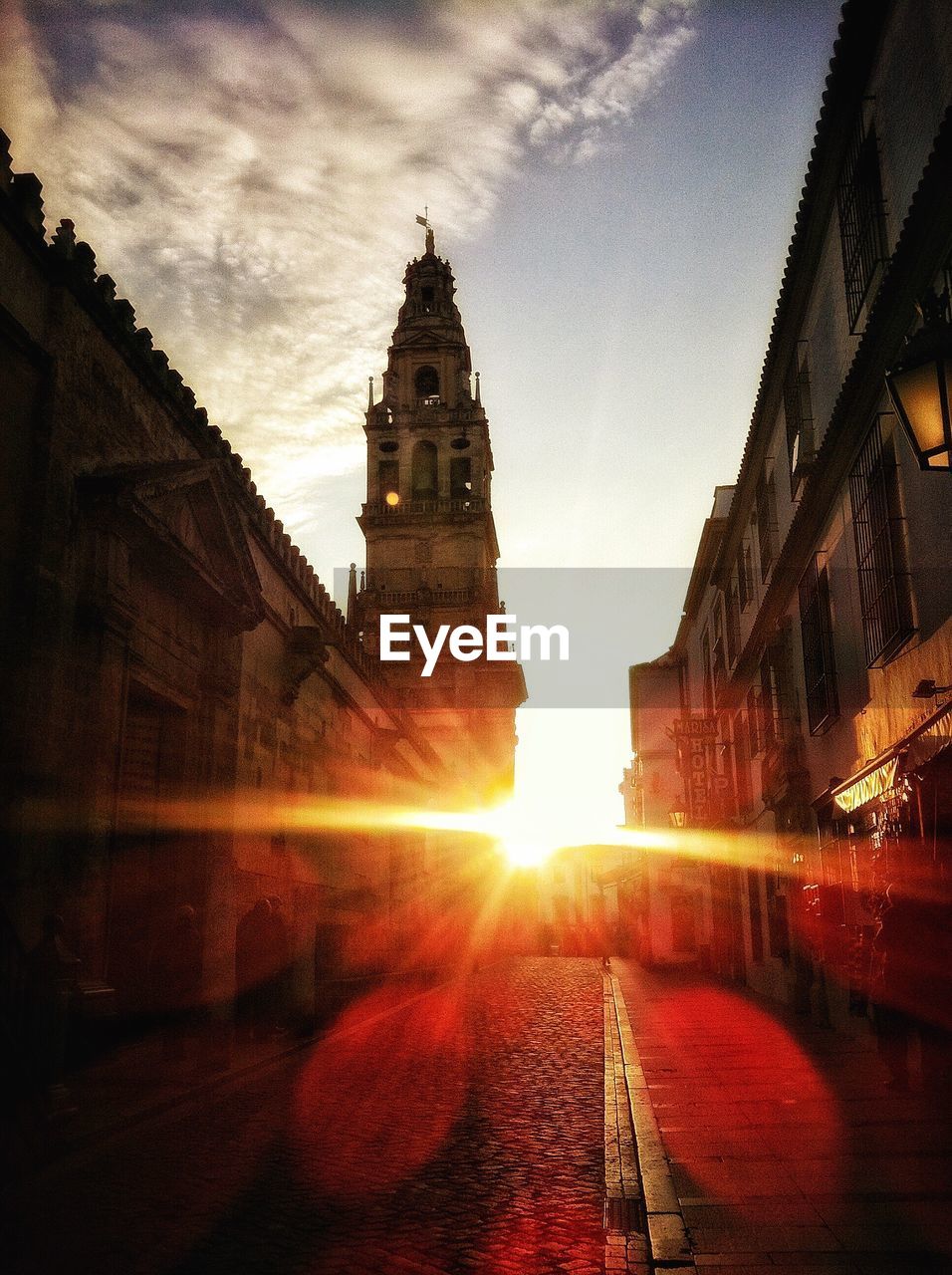 Sunlight with lens flare over old buildings