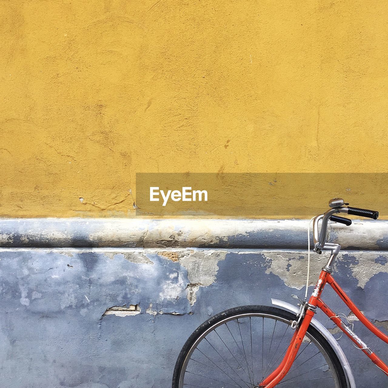 Close-up of bicycle against wall