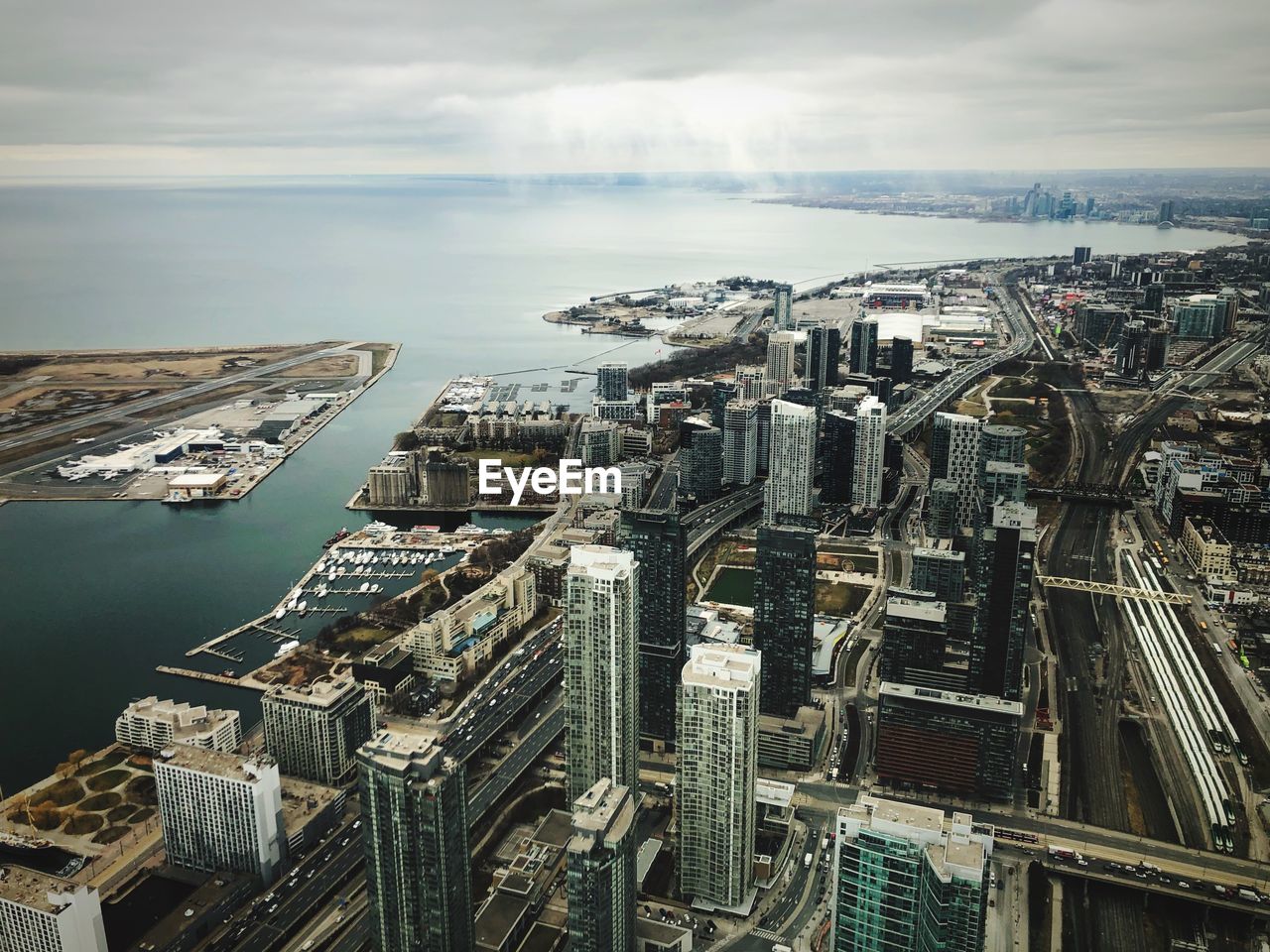 High angle view of buildings by sea against sky