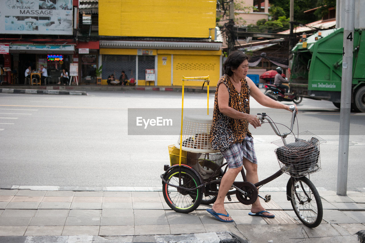 WOMAN RIDING BICYCLE ON STREET