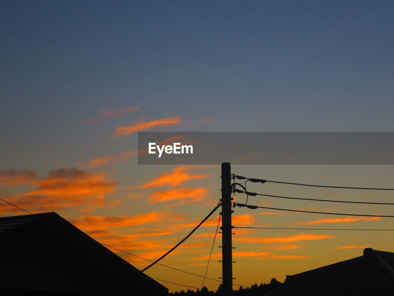 LOW ANGLE VIEW OF POWER LINES AGAINST CLOUDY SKY