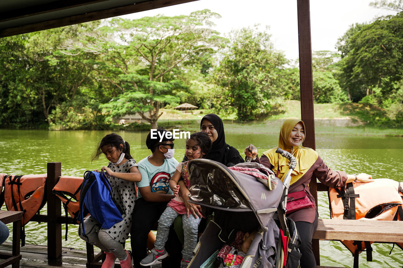 GROUP OF PEOPLE SITTING IN PARK