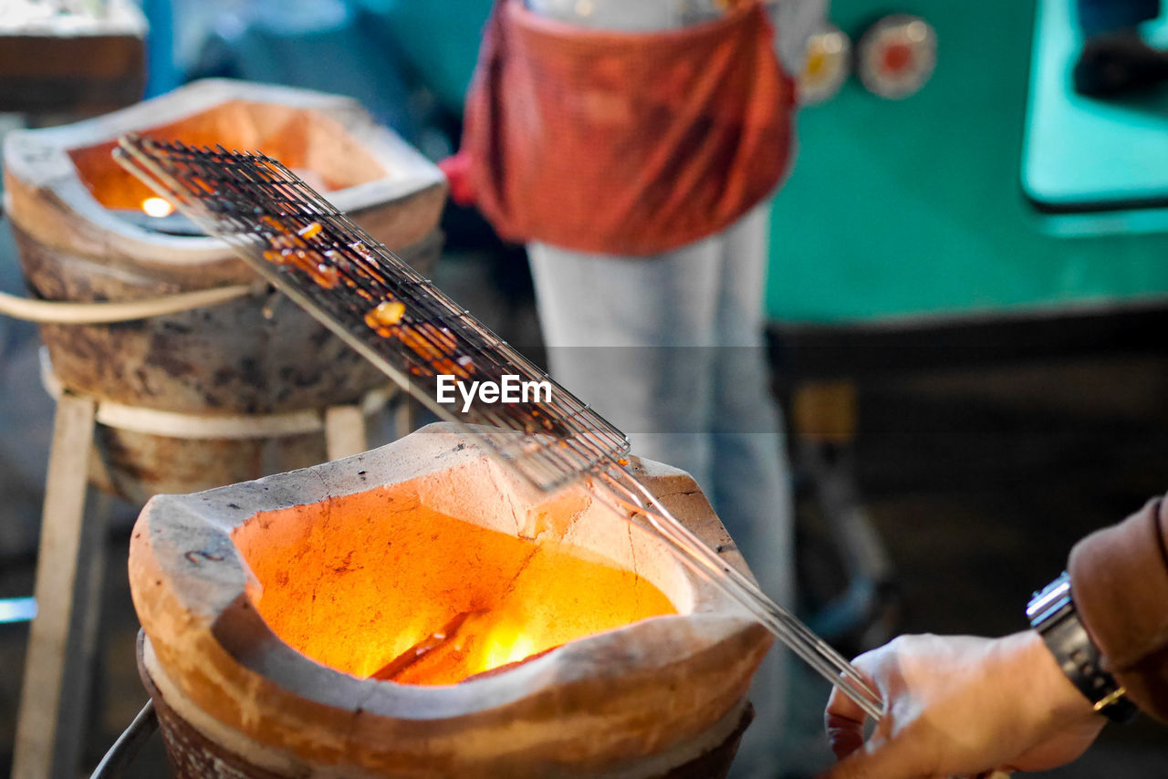 Cropped hand of person preparing food