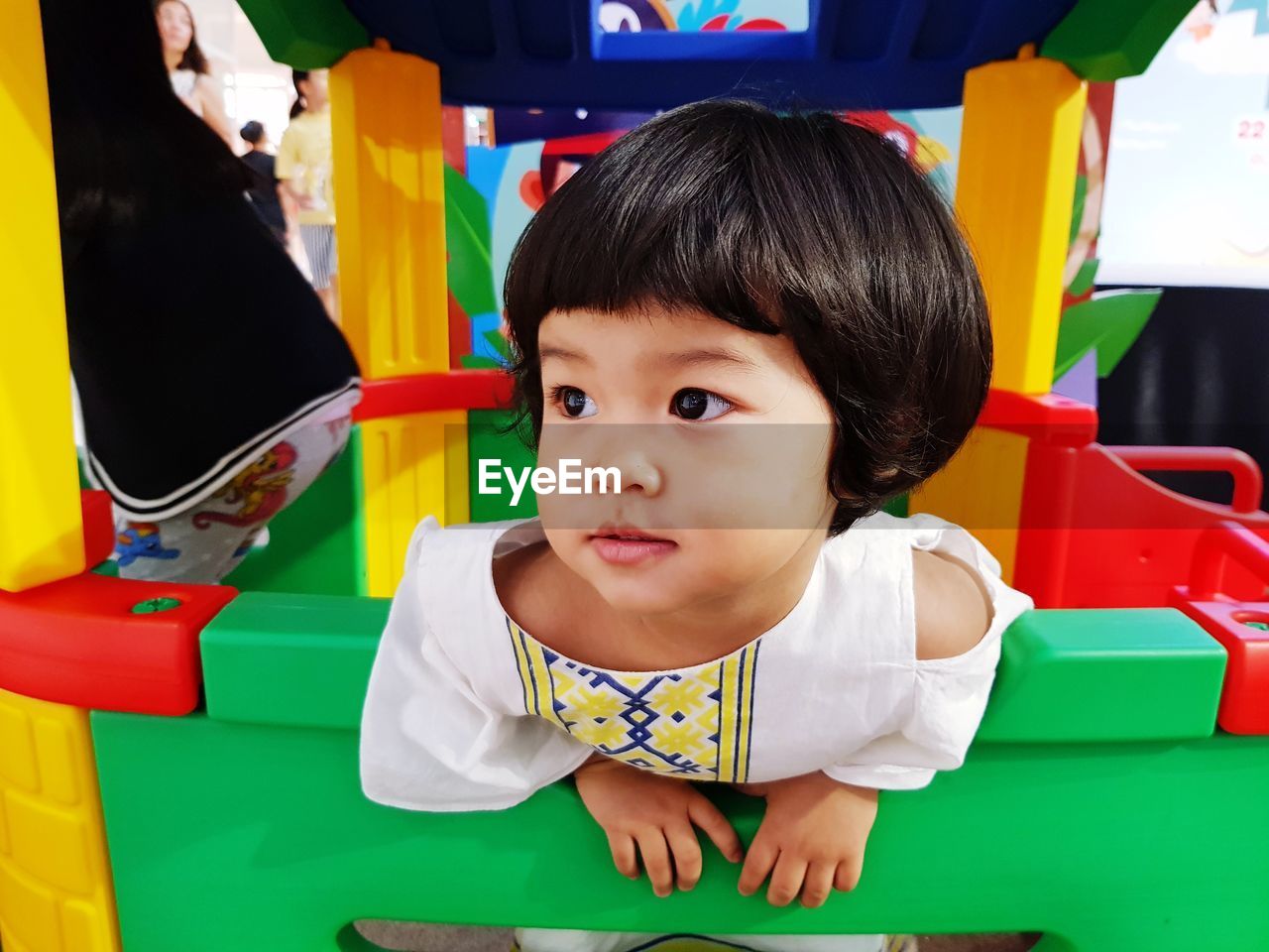 Close-up of cute baby girl on colorful toy