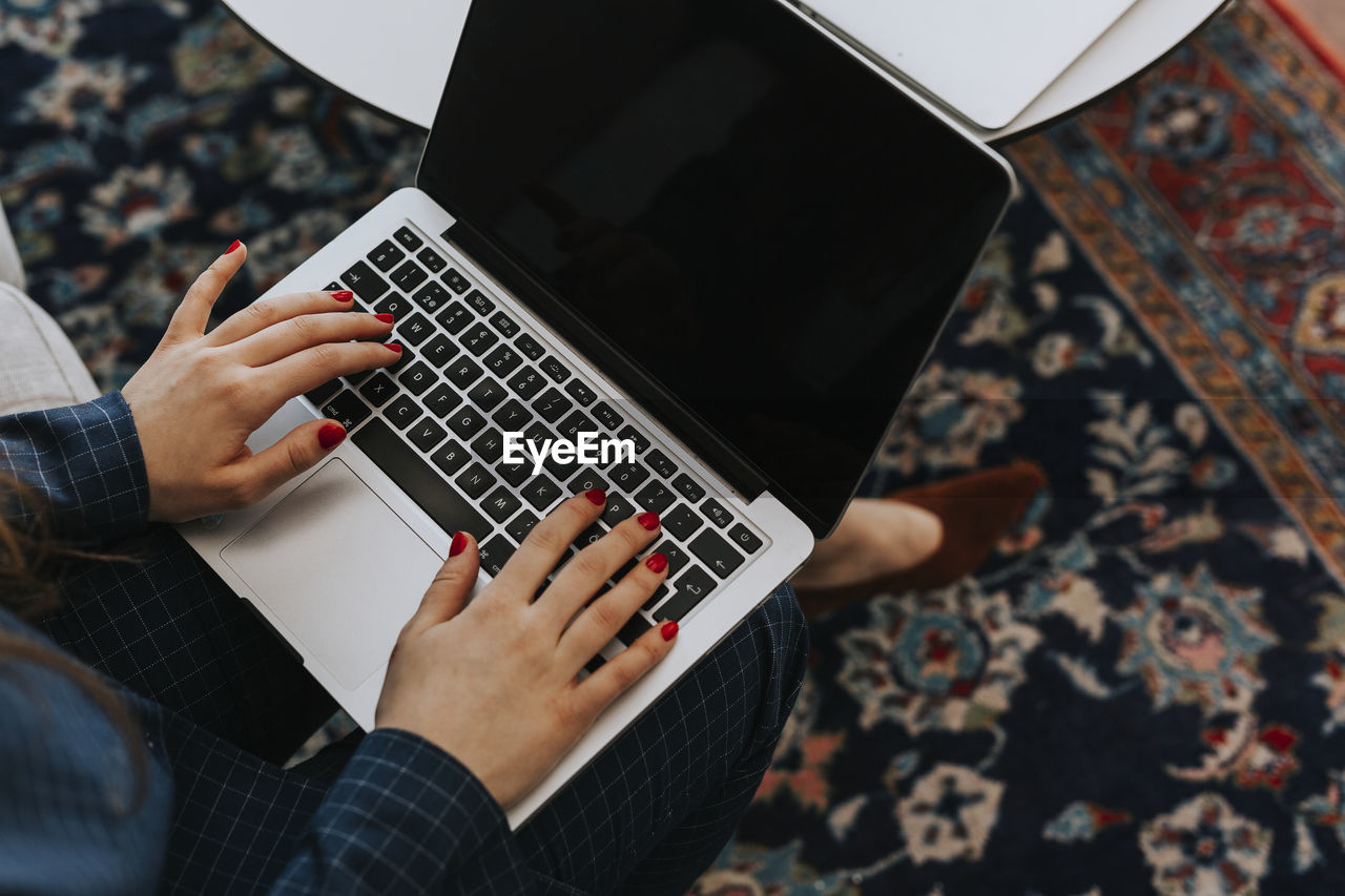 Woman's hands on laptop keyboard