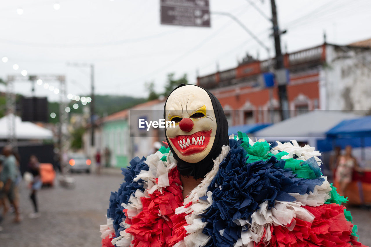 People wearing horror masks are seen playing during the carnival 