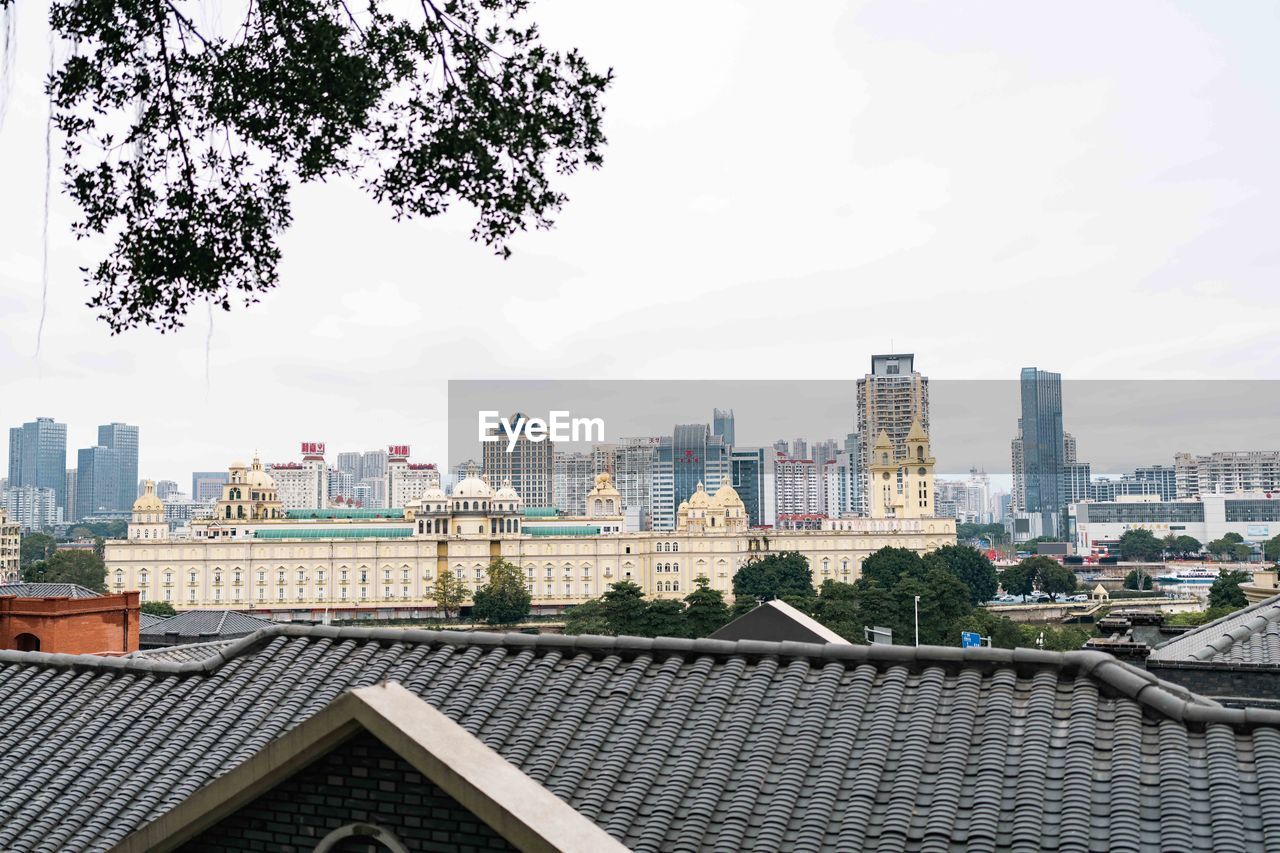 architecture, building exterior, built structure, city, building, sky, skyline, cityscape, roof, skyscraper, office building exterior, residential district, urban skyline, landscape, urban area, nature, downtown, residential area, landmark, city life, no people, cloud, day, travel destinations, outdoors, metropolitan area, high angle view, tree, downtown district, house, neighbourhood