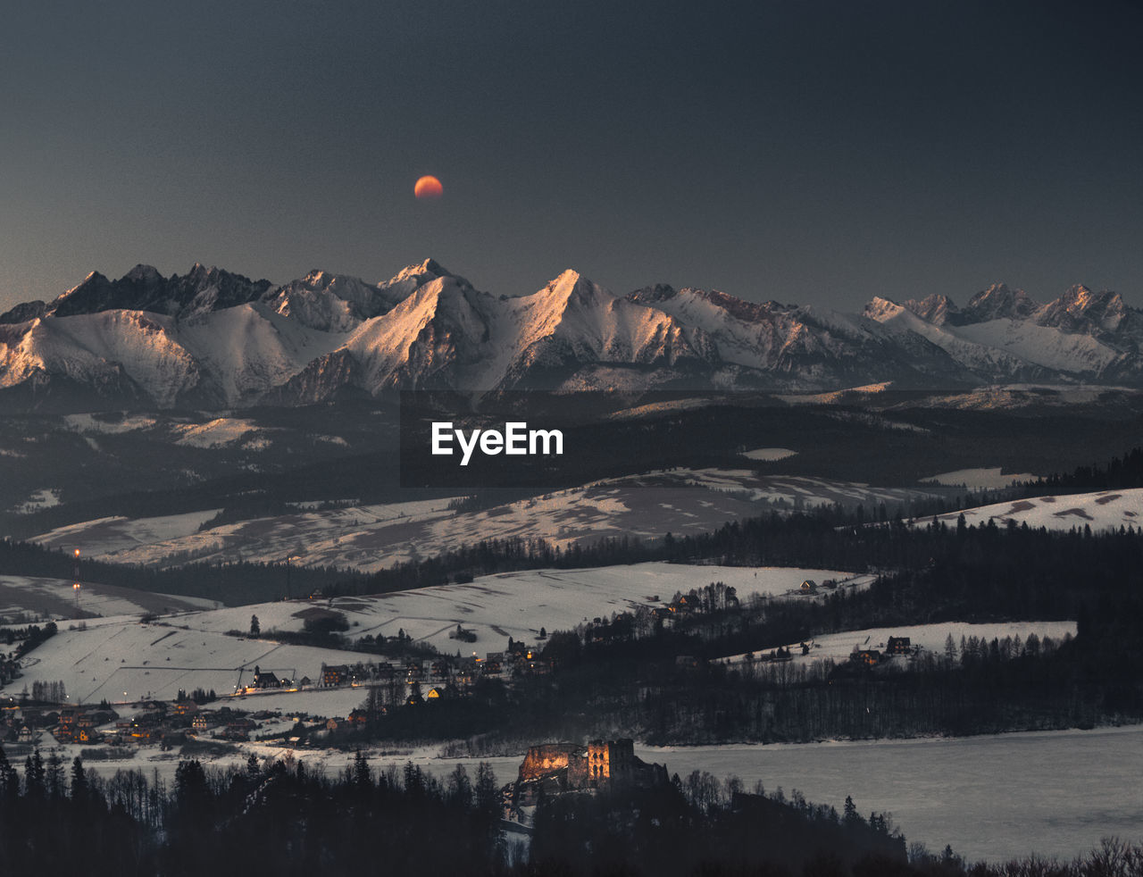 Scenic view of snowcapped mountains against sky during winter