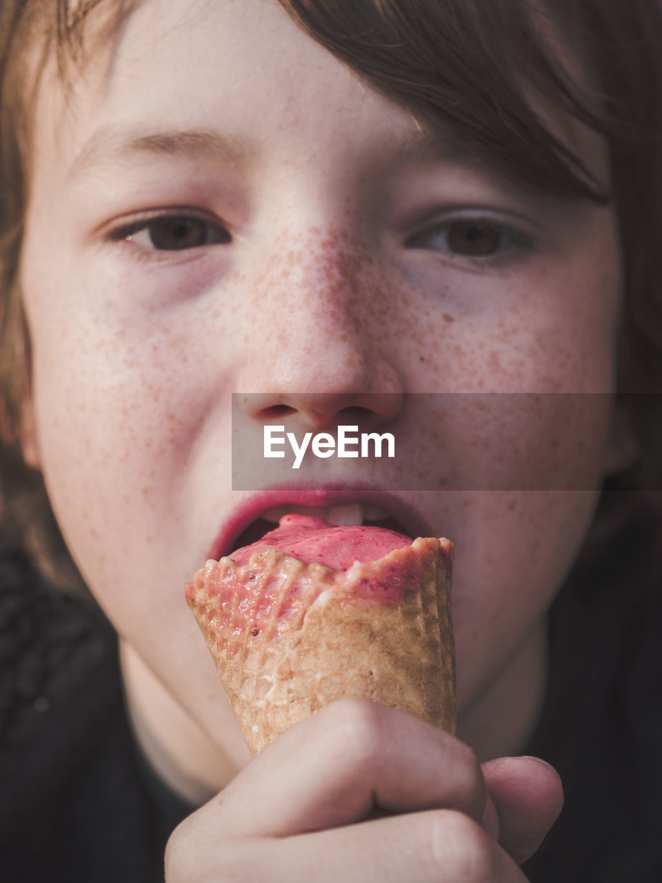 Close-up of boy licking ice cream