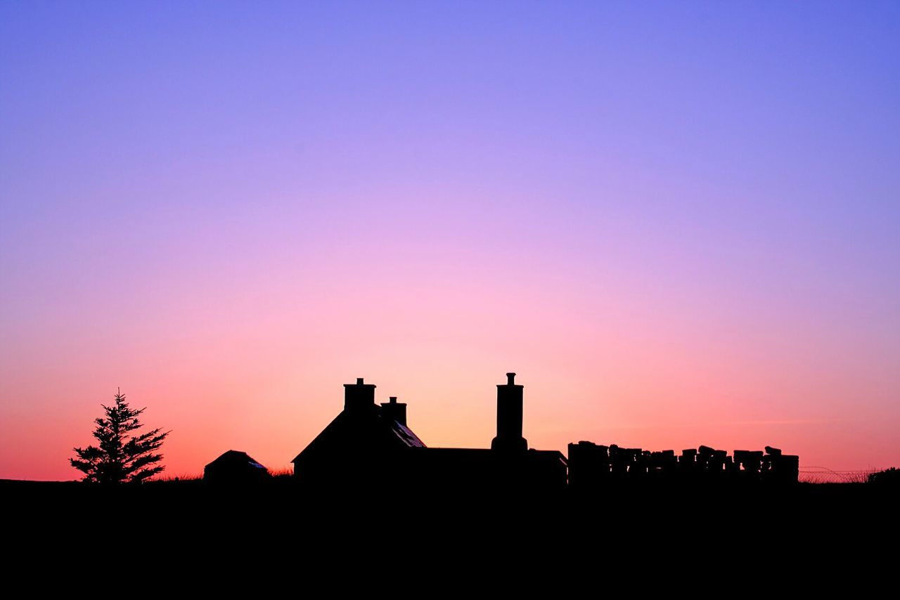 SILHOUETTE OF BUILT STRUCTURE AT SUNSET