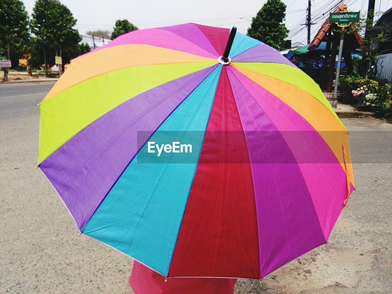 CLOSE-UP OF UMBRELLA ON WET STREET IN CITY