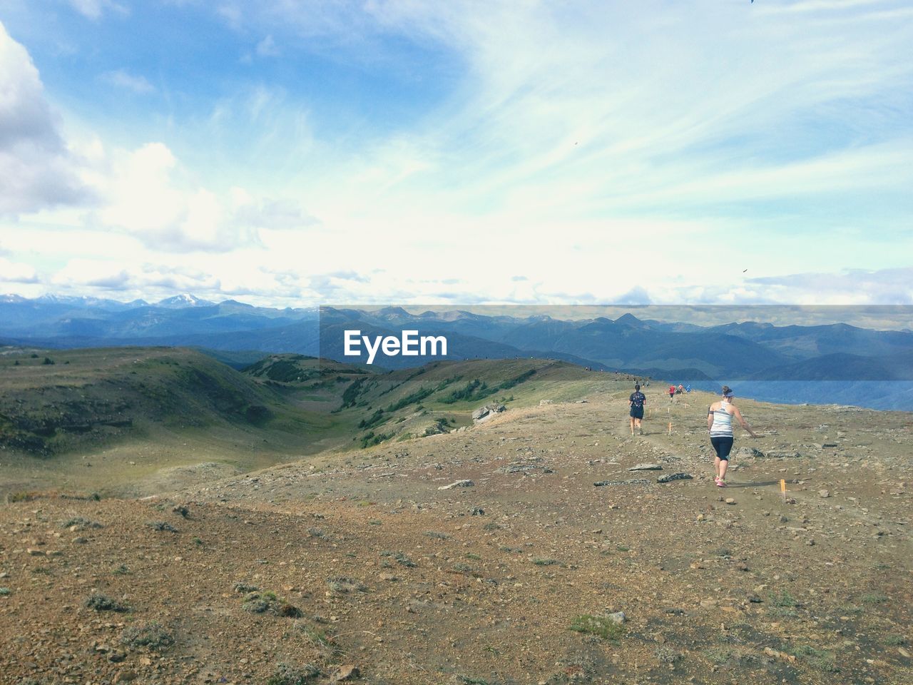 WOMAN STANDING ON MOUNTAIN