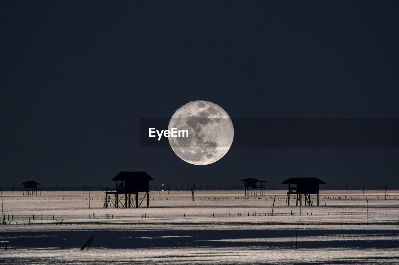 Scenic view of moon against clear sky at night