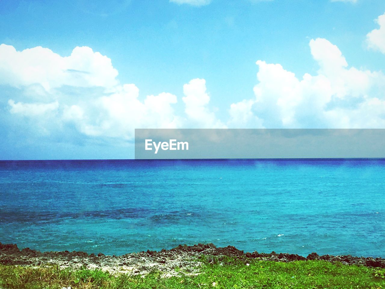 VIEW OF CALM BLUE SEA AGAINST CLOUDS