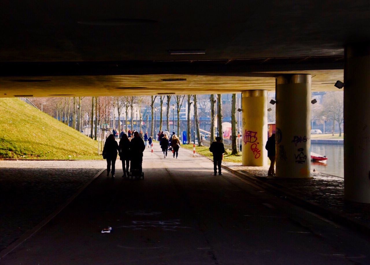 PEOPLE IN ILLUMINATED TUNNEL