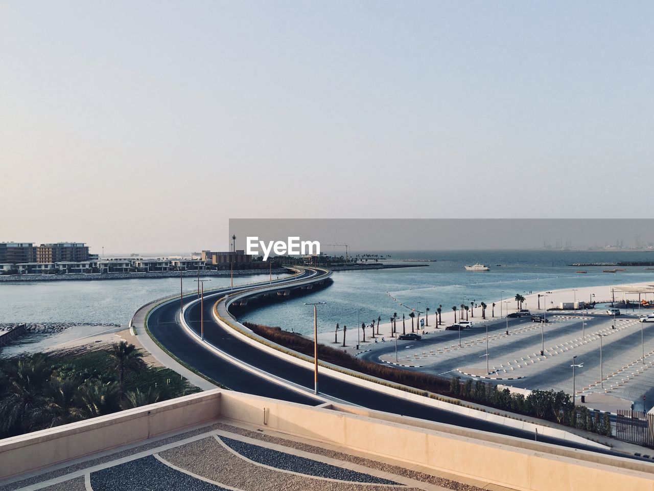 High angle view of city by sea against clear sky