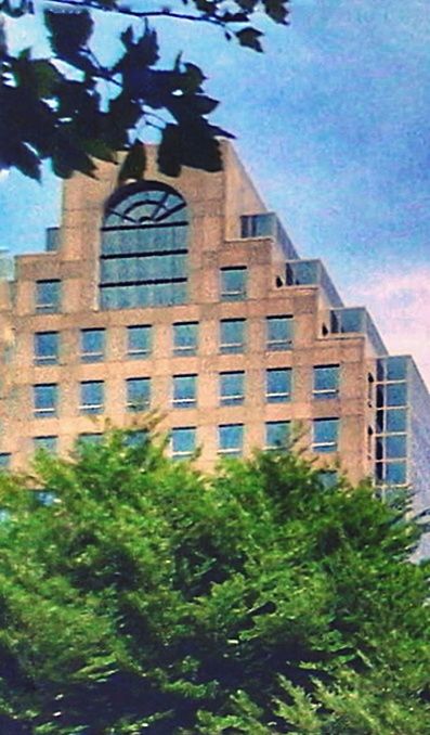 LOW ANGLE VIEW OF BUILDING WITH TREES IN BACKGROUND