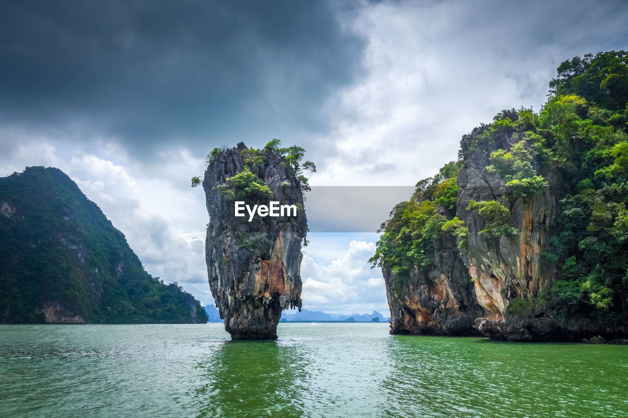 SCENIC VIEW OF ROCK FORMATION AMIDST SEA AGAINST SKY