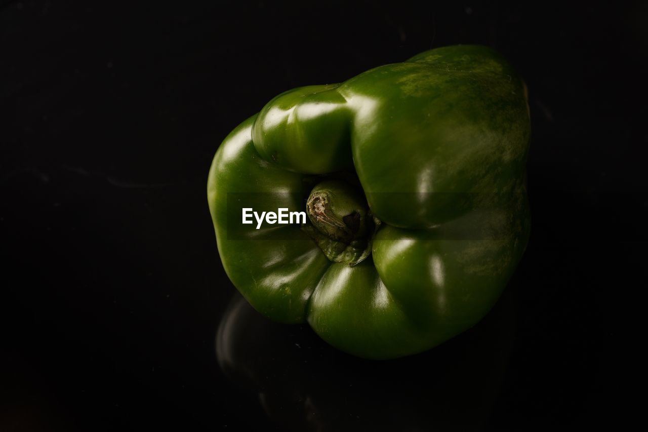 Close-up of green bell pepper on black background