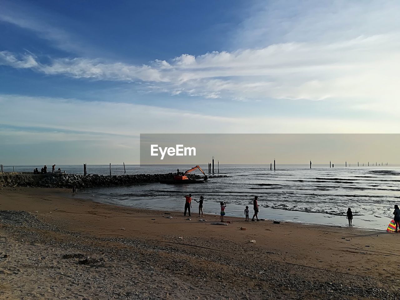 PEOPLE AT BEACH AGAINST SKY