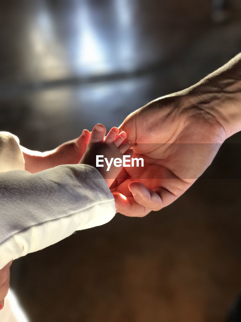 Cropped image of parent touching baby foot