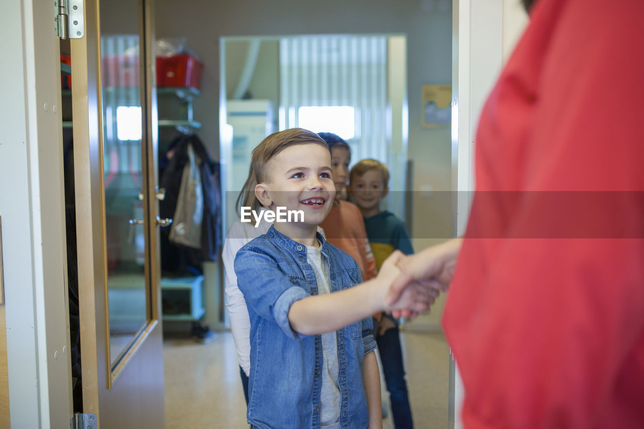 Boy shaking teachers hand