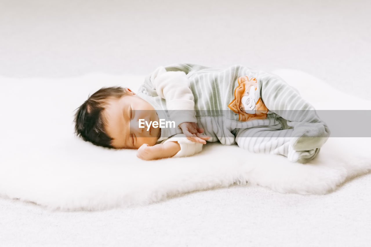 Cute baby sleeping on bed