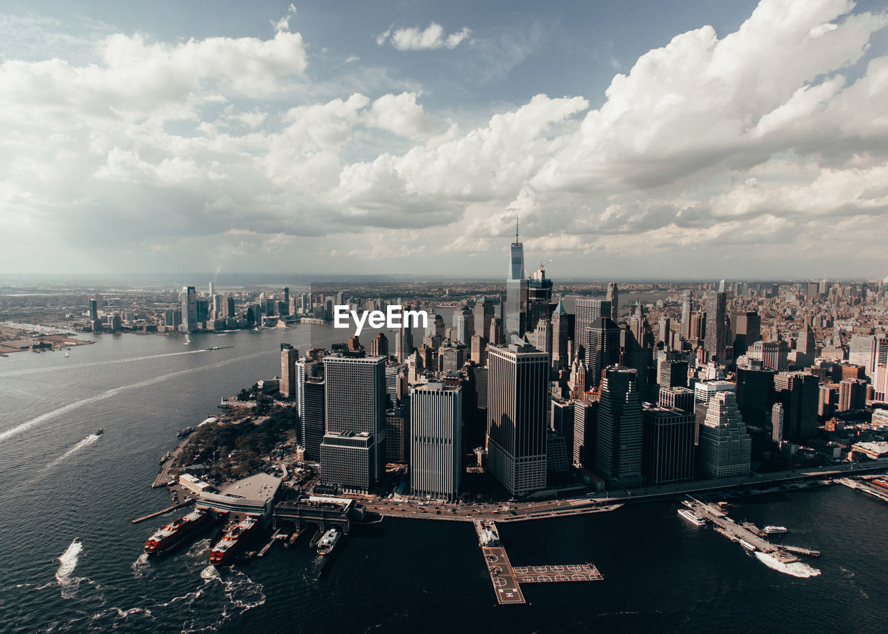 Panoramic view of city buildings against cloudy sky new york city