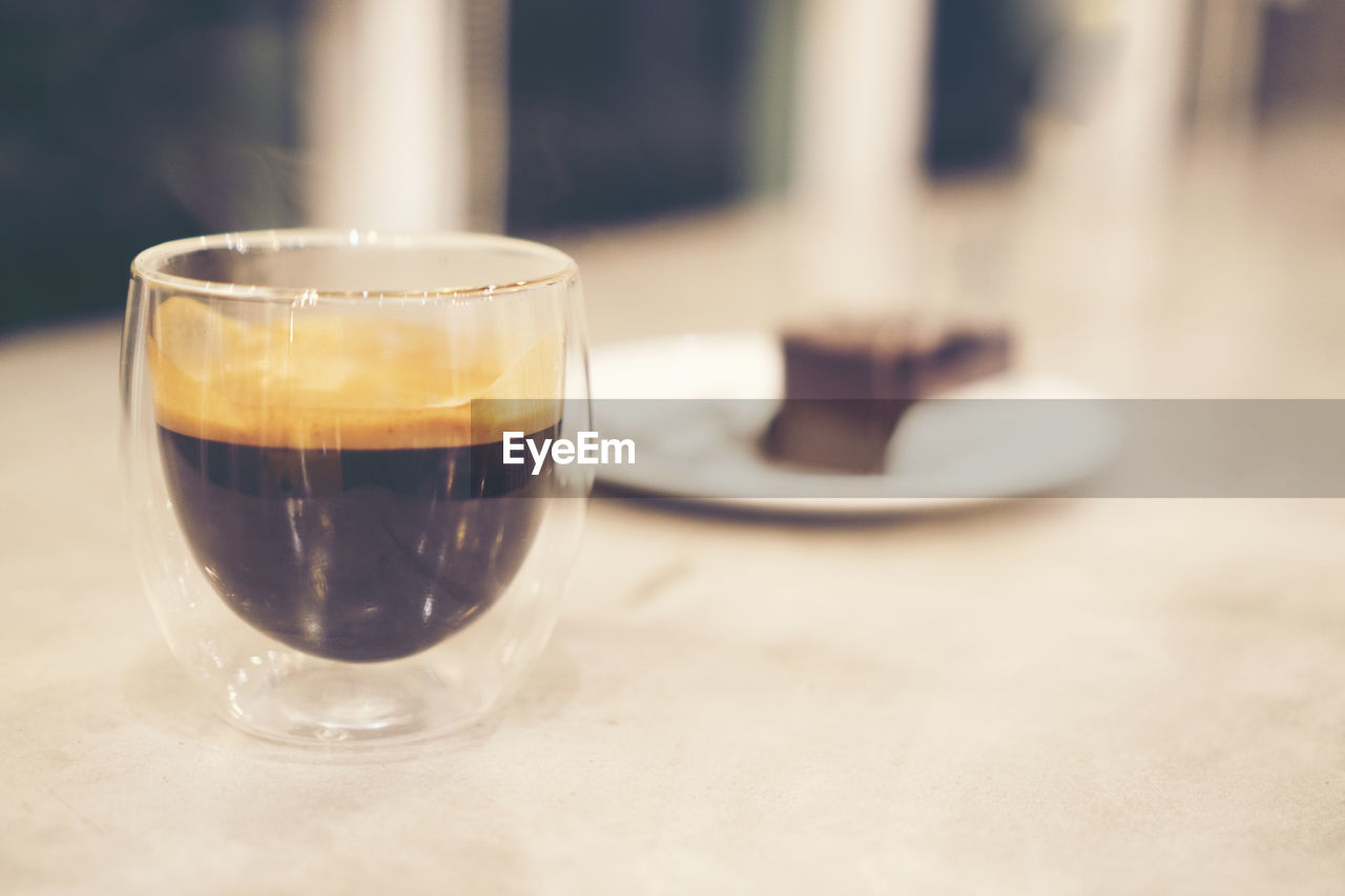 CLOSE-UP OF COFFEE IN GLASS