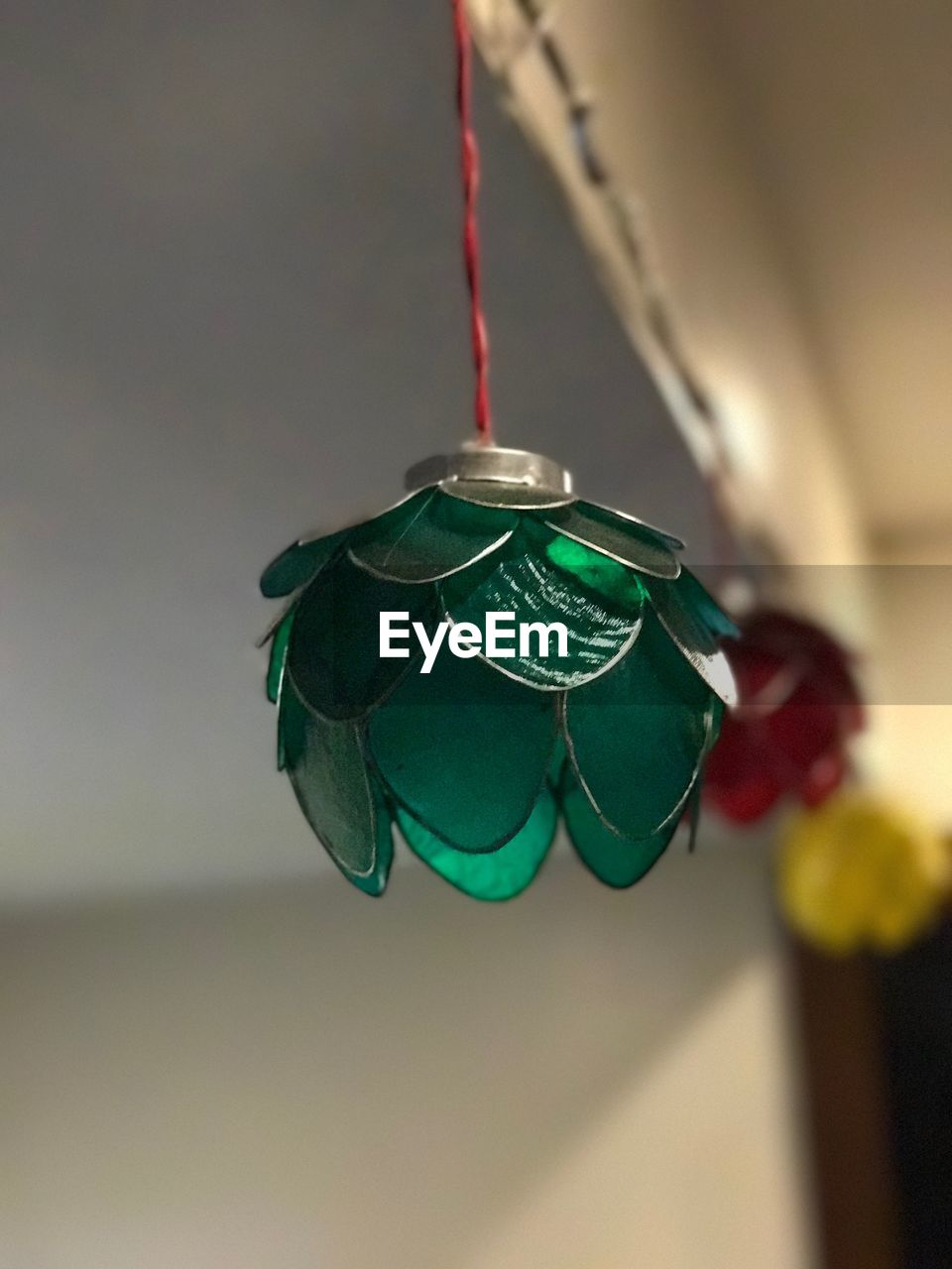 CLOSE-UP OF CHRISTMAS DECORATIONS HANGING ON STRING