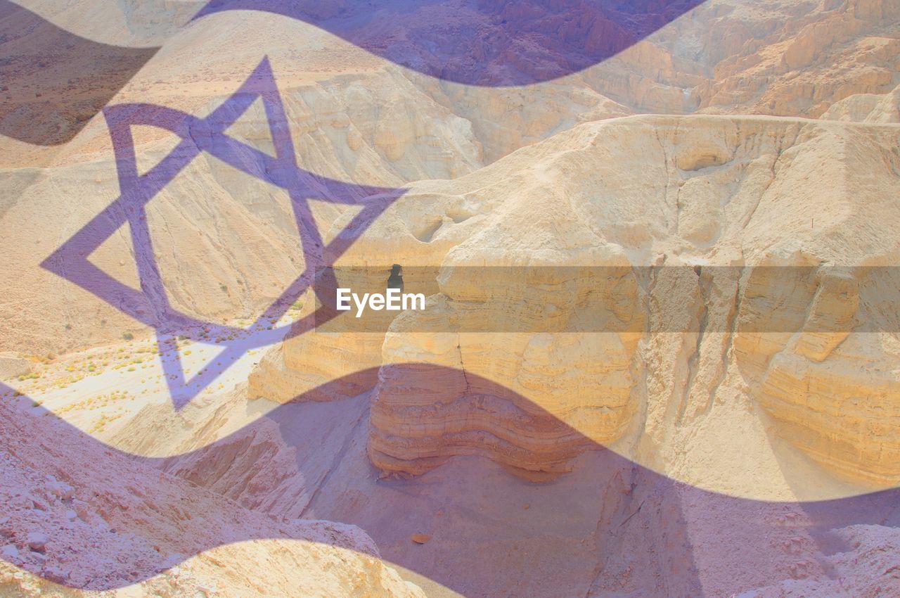 Israeli flag over desert in israel