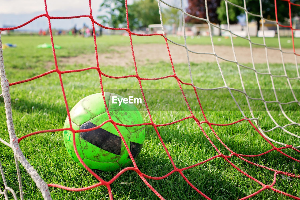 grass, sports, net, soccer, net - sports equipment, green, soccer field, team sport, plant, nature, sports equipment, no people, playground, lawn, player, soccer goal, focus on foreground, day, playing field, goal, outdoors, football, close-up, ball