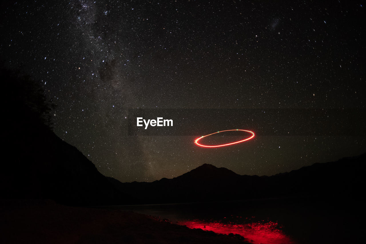 Scenic view of lake against star field at night