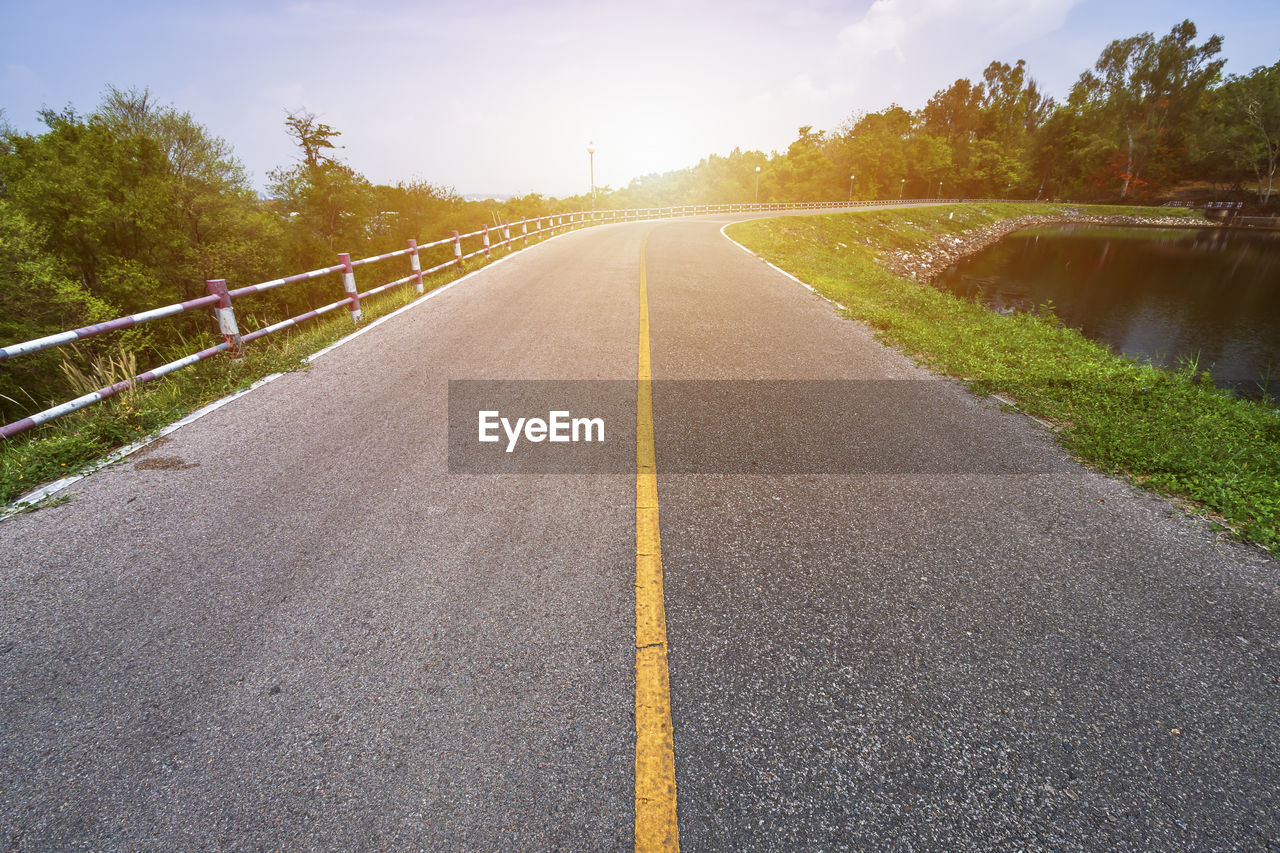 SURFACE LEVEL VIEW OF ROAD AGAINST SKY