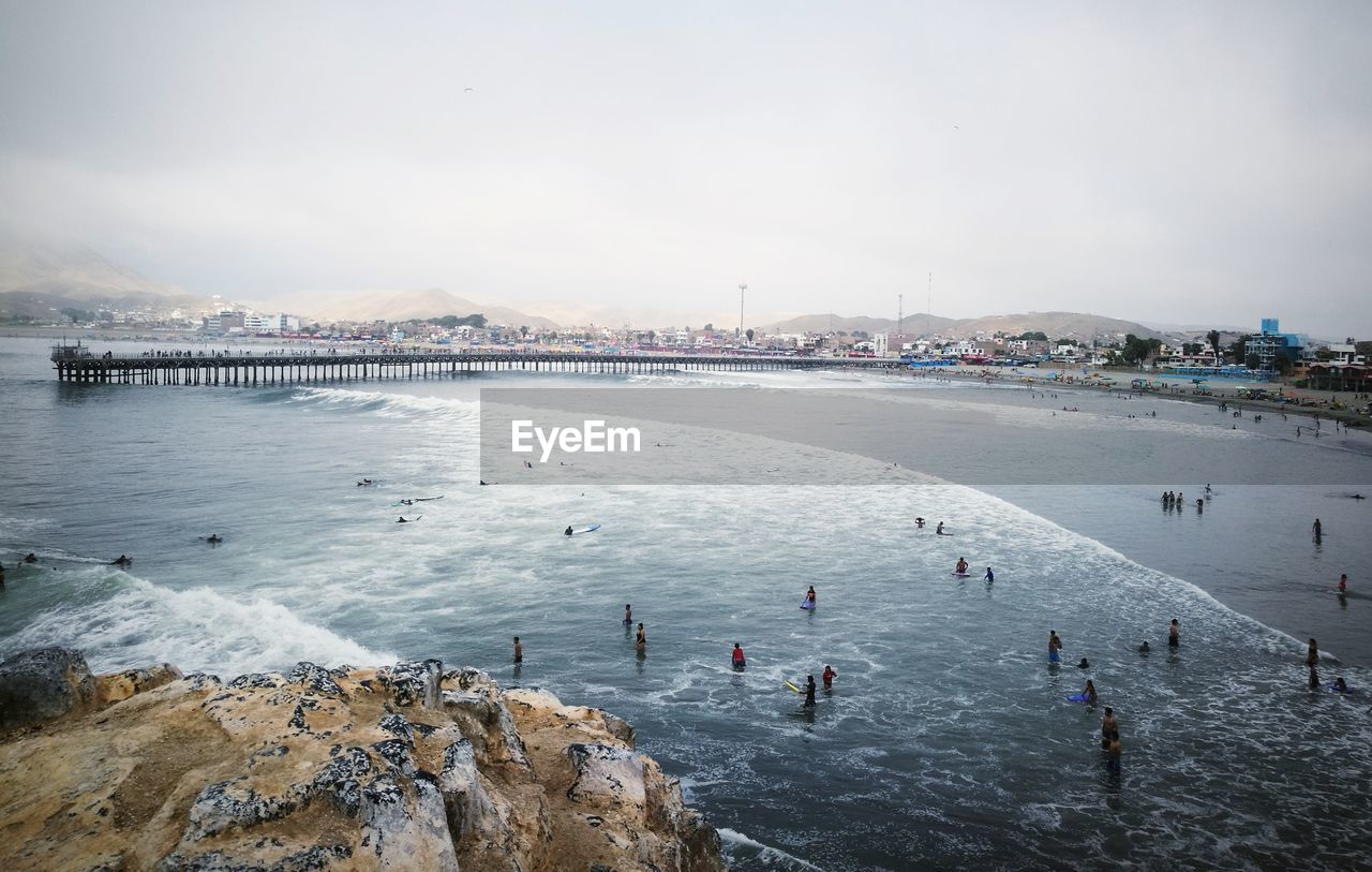 High angle view of people at beach against sky