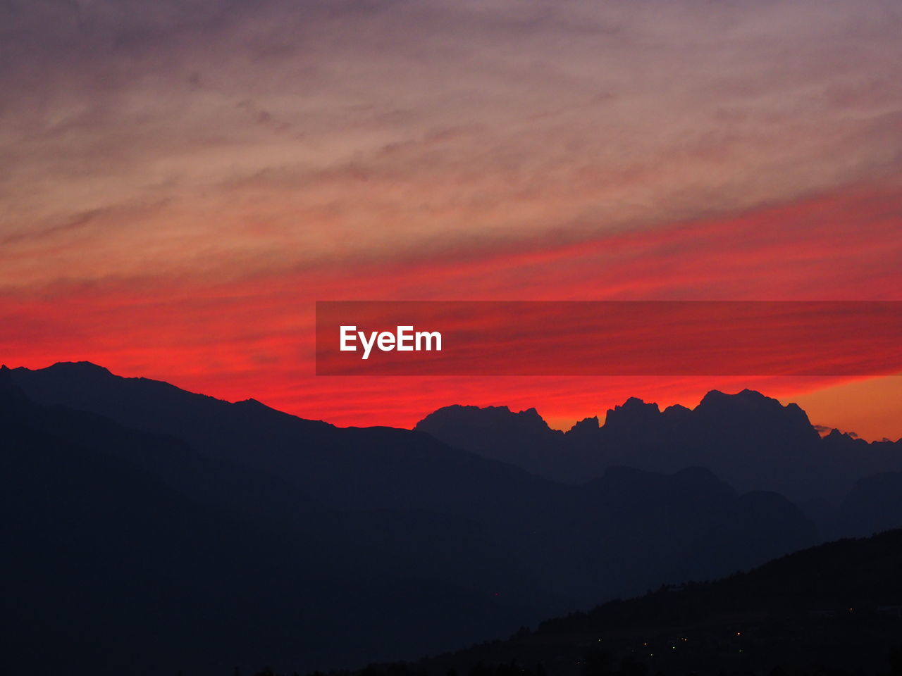 Scenic view of silhouette mountains against sky during sunset