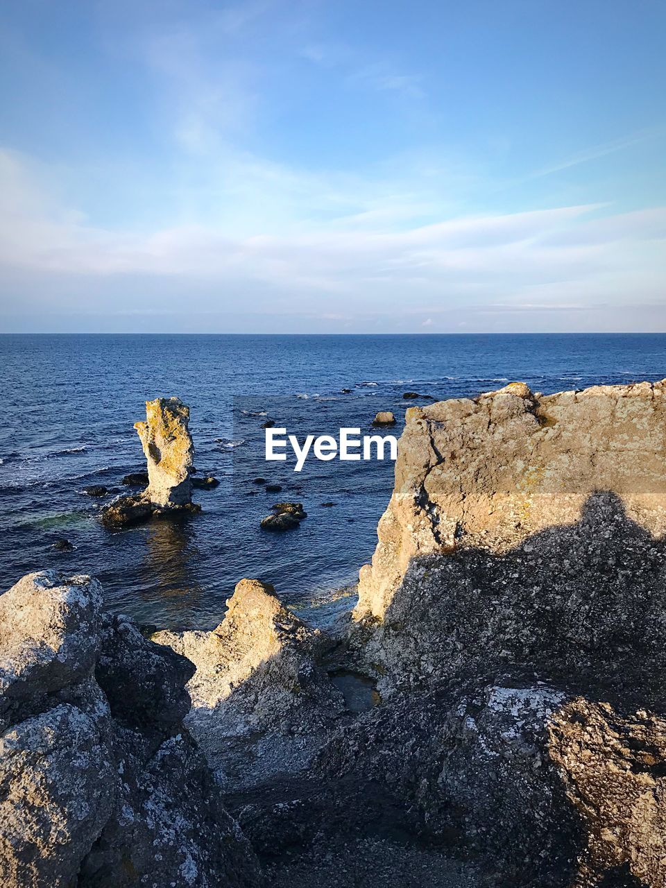 ROCK FORMATION BY SEA AGAINST SKY