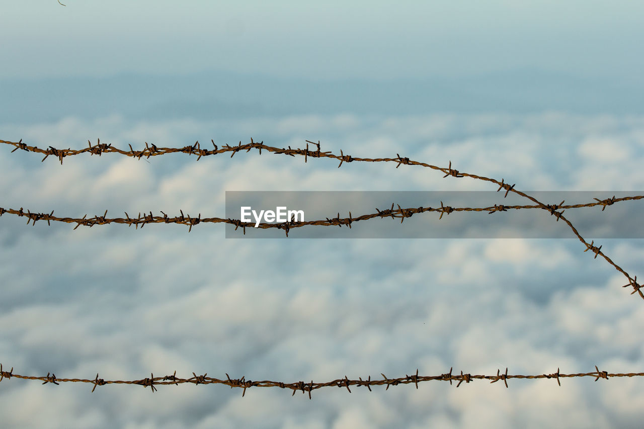 LOW ANGLE VIEW OF FENCE AGAINST SKY