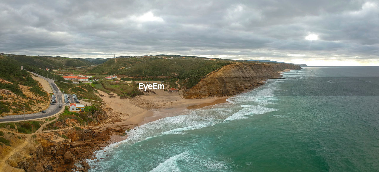 Aerial view of waves on a beautiful sandy ocean beach and cliff. panorama atlantic coastline.