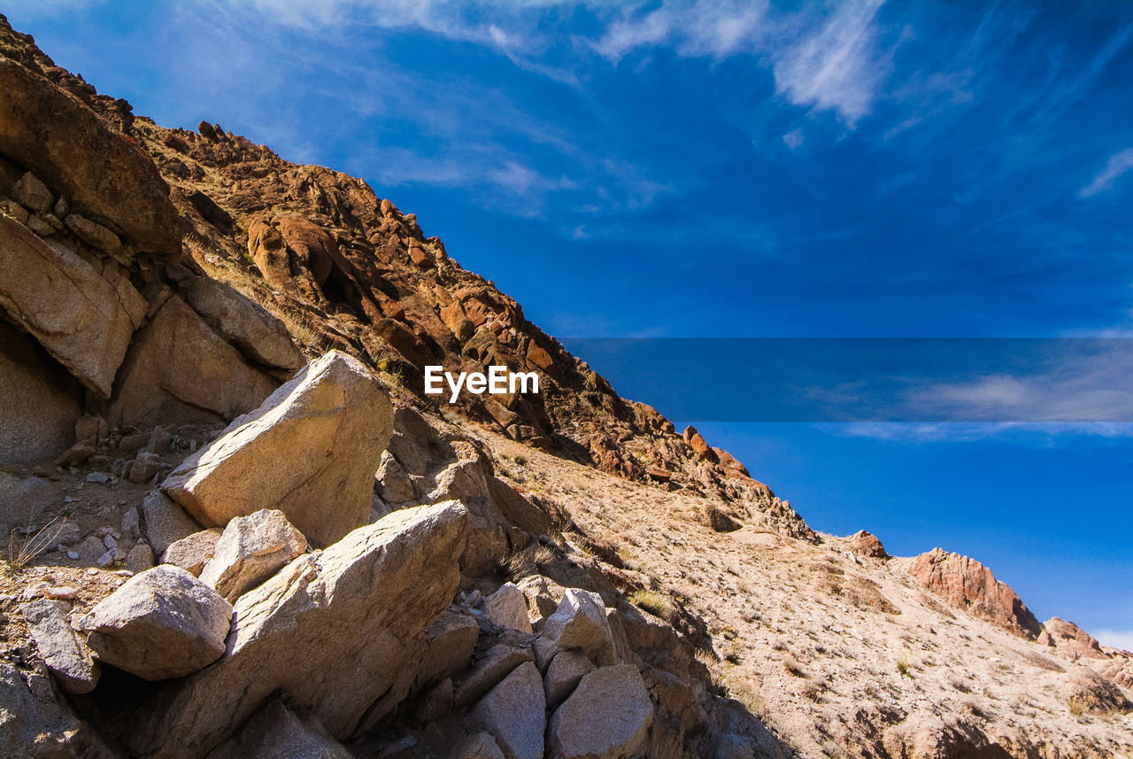 Close-up of sand on beach against blue sky