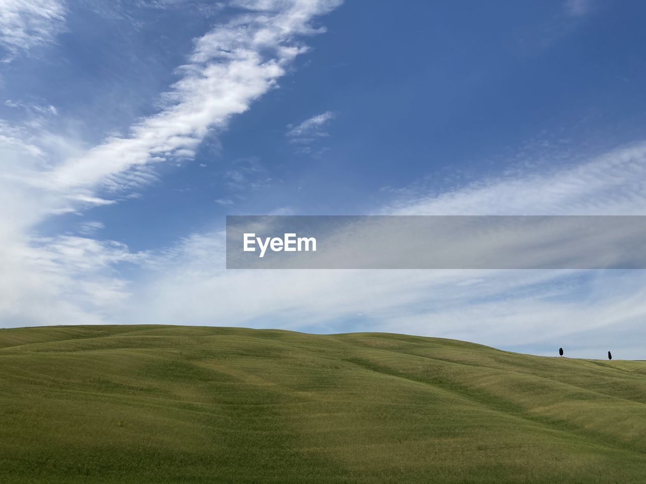 sky, grassland, horizon, environment, landscape, plain, grass, cloud, hill, field, land, scenics - nature, nature, beauty in nature, prairie, plant, green, meadow, blue, plateau, steppe, tranquility, non-urban scene, horizon over land, tranquil scene, pasture, rural scene, day, leisure activity, golf, outdoors, activity, no people, golf course, sports, rural area, sunlight, natural environment, cloudscape, travel, summer, idyllic, travel destinations, rolling landscape, copy space