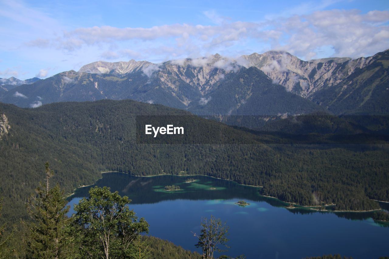 Scenic view of lake and mountains against sky