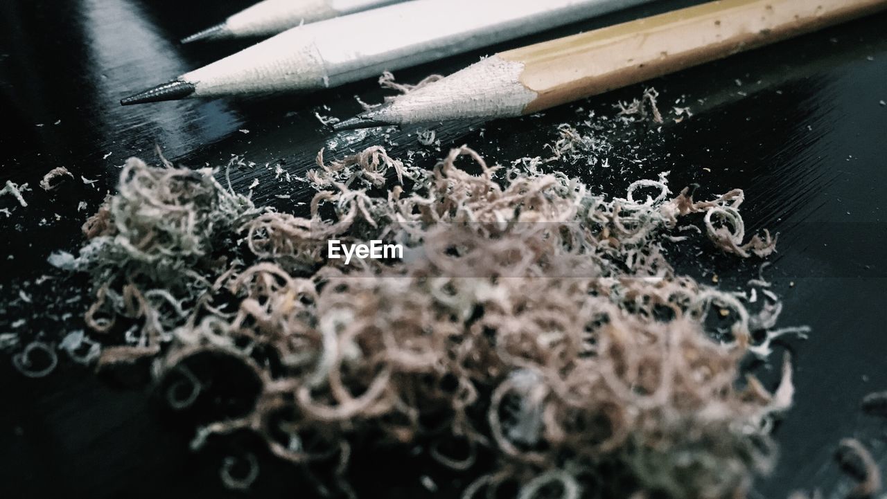 Close-up of pencils and shavings on table